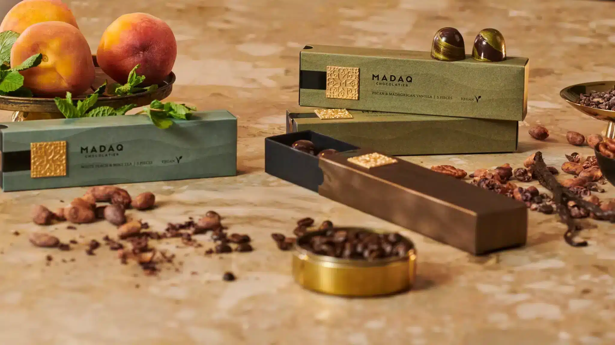 Madaq products and ingredients lined up on a marble countertop
