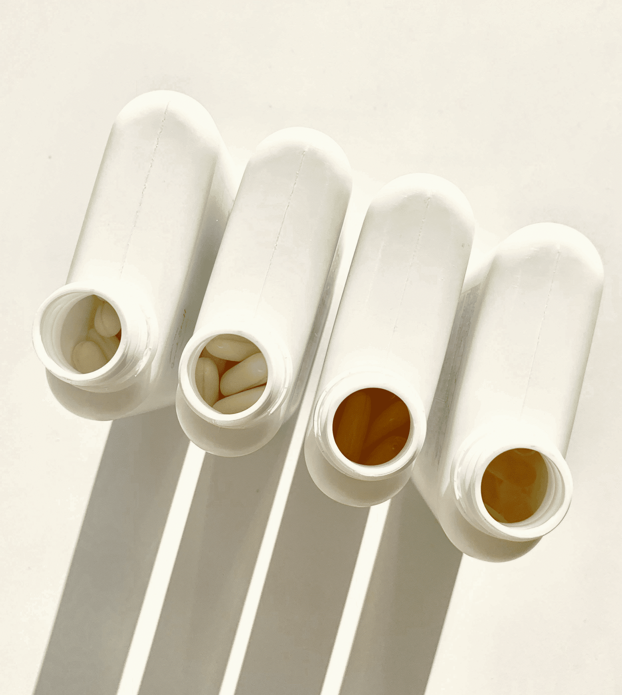 White medicine bottles lined up
